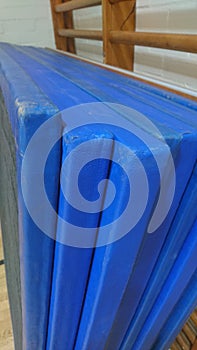 A set of worn royal blue gymnastics mats
