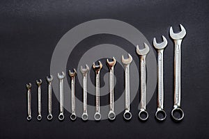 Set of wrenches on black background. Tools spanners. Technique repair, equipment for mechanical service, labor or father`s day