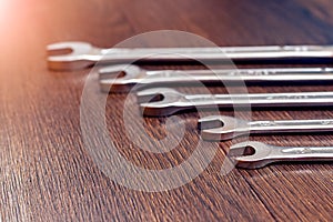 Set of wrenches on a wooden table. Wrenches of different sizes