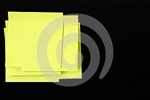 Set of yellow folded note paper sheets on black background