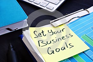 Set your business goals. Stack of financial documents.