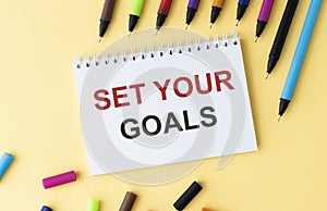 Set your goals words written on lined paper