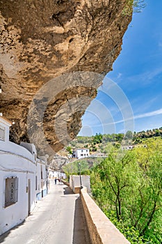 Setenil de las Bodegas, Spain - April 6, 2023: Typical Andalucian village with white houses and sreets with dwellings built into