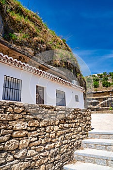 Setenil de las Bodegas. Typical Andalucian village with white houses and sreets with dwellings built into rock overhangs above Rio