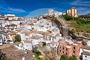Setenil de las Bodegas. Typical Andalucian village with white houses and sreets with dwellings built into rock overhangs above Rio