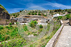 Setenil de las Bodegas. Typical Andalucian village with white houses and sreets with dwellings built into rock overhangs above Rio