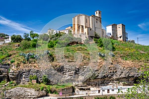 Setenil de las Bodegas. Typical Andalucian village with white houses and sreets with dwellings built into rock overhangs above Rio photo