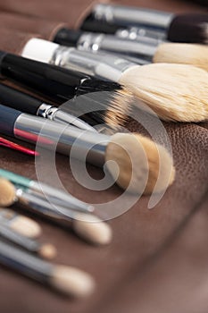 Seto of make up artists brushes laying on the table, clean and ready to use. Space for text