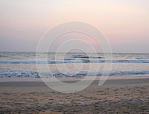 Setting Red Sun at Horizon over Sea at Payyambalam Beach, Kannur, Kerala, India