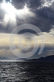 The setting sun in the clouds over the Aegean Sea