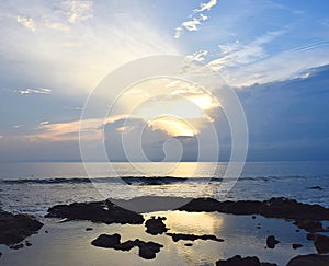 Setting Sun among Clouds over Ocean at Horizon with Bright Golden Sunrays in Sky - Neil Island, Andaman Nicobar, India