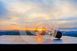 Setting Sun Glowing through a Light Bulb Outdoors