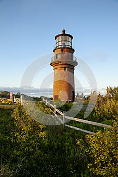 Setting Sun Illuminates Brick Lighthouse Tower in New England