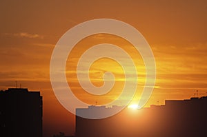 The setting sun over urban residential buildings