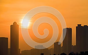 The setting sun in the plumes of a sandstorm