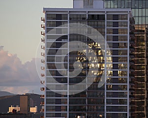 The setting sun reflects the face of modern architecture.