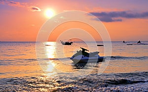 The setting sun sea, fishing boats, motor boats