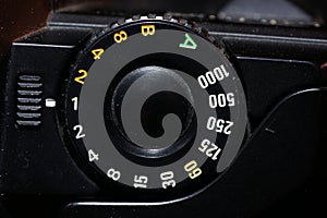 Setting wheel for ISO and aperture on an old camera photographed in the studio