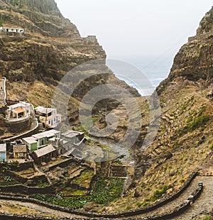 Settlement in the rocky coast of Santo Antao island. Houses nestle into the sides of bluff ridge. Fontaihas village