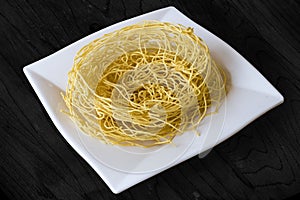 Sev crunchy noodle popular Indian namkeen snack food made from chickpea flour paste, turmeric, cayenne, and ajwain