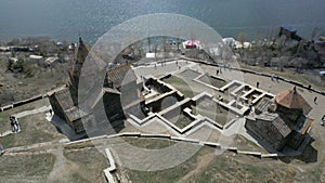 Sevan Monastery. View from above, Lake Sevan, mountains, grass, sky, people