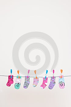 Seven Babies Socks On Washing Line