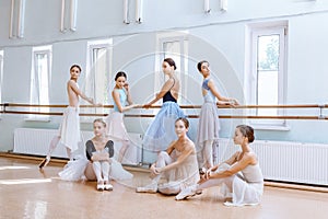 The seven ballerinas at ballet bar