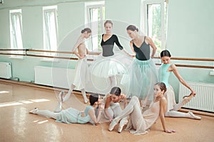 The seven ballerinas at ballet bar