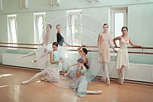 The seven ballerinas at ballet bar