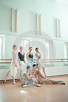 The seven ballerinas at ballet bar