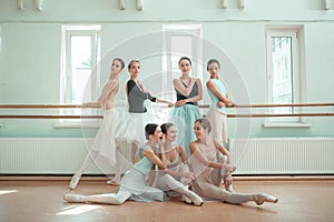 The seven ballerinas at ballet bar