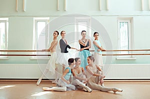 The seven ballerinas at ballet bar