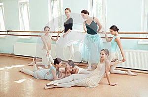 The seven ballerinas at ballet bar