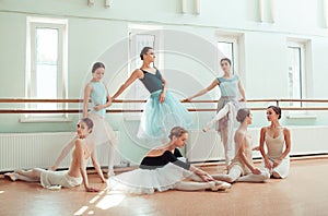 The seven ballerinas at ballet bar