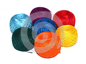 Seven balls of rainbow yarn