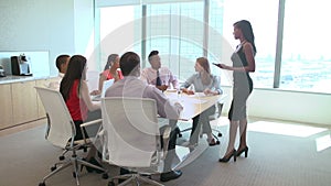 Seven Businesspeople Having Meeting Around Boardroom Table