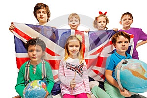 Seven English kids studying geography with globes