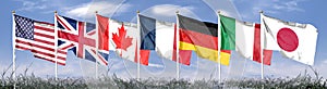 Seven flags of the Group of Seven are developing against the blue sky. G7 photo