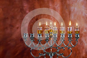 Seven Hanukkah candles are burning on light of jewish holiday sixth day of the Jewish holiday Hanukkah