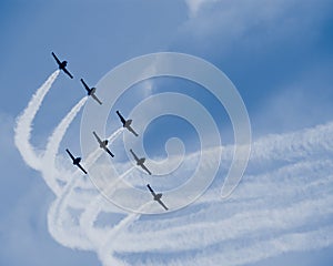 Seven jet airplanes with white smocks photo