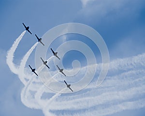 Seven jet airplanes with white smocks