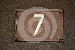 Seven on Metal Background