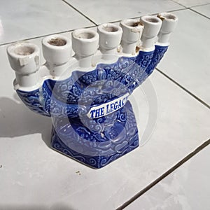 seven-pronged candle holder in blue and white with a white floor
