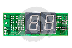 Seven segment indicators on a green circuit board isolated on white background