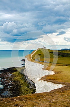 Seven sisters cliffs on the cloudy day. Deep blue sea and chalk cliffs in the summer.