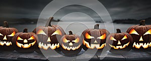 Seven spooky halloween pumpkins, Jack O Lantern, with an evil face and eyes photo