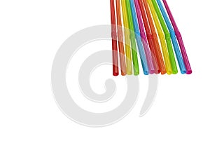 Seven straws of rainbow colors lie on a white background. Bright colors. The colors symbolize the concept of unification
