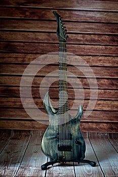 Seven-string electric guitar made of dark wood. Background for music and creativity