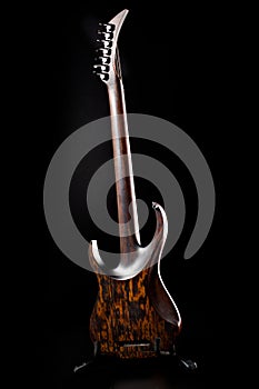 Seven-string electric guitar made of dark wood. Background for music and creativity