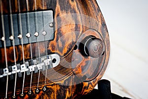 Seven-string electric guitar made of dark wood. Shot on a white background. Background for music and creativity